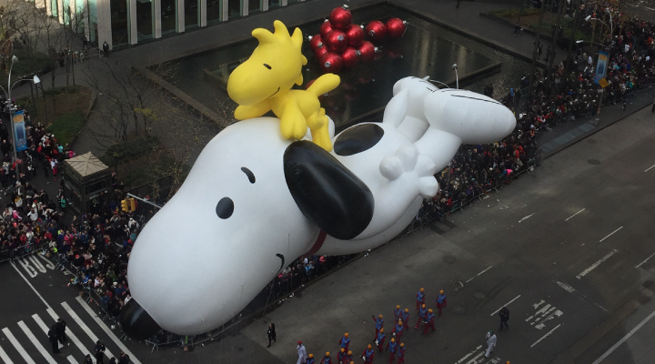 Woodstock the yellow cartoon bird from “Peanuts” sits atop Snoopy as they glide through the Macy’s Thanksgiving Day parade.